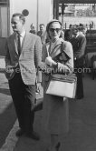 Grace Kelly with the original Kelly Bag arriving at Cannes station 1955. With her is Rupert Allan. - Photo by Edward Quinn