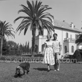 Prince Sadruddin ("Sadri") Aga Khan and his mother Princess Andrée, third wife of Aga Khan, at their home in Cap d’Antibes in 1954. with their attentive spaniel. - Photo by Edward Quinn