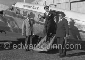 La Môme Moineau (the kid sparrow), "the richest woman of the Côte d'Azur", former flower seller, getting off her private plane Beech 18. On the right, her husband Mr. Benítez-Rexach, Dominican ship building millionaire. Cannes 1954. - Photo by Edward Quinn