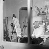 Pablo Picasso doing the charcoal drawing "Vue de Village" of the view from Le Fournas. Vallauris 26.6.1953. - Photo by Edward Quinn