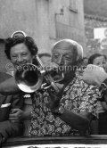 Among the locals in Vallauris, Pablo Picasso sets the pace at the festival by showing his "skill" on the trumpet, which he could not play at all. At the parade which proceeded the bullfight staged by Pablo Picasso at Vallauris 1954. - Photo by Edward Quinn