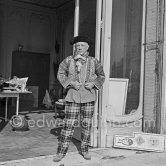 Pablo Picasso in a whimsical costume. Among other things, he has on a bullfighter’s jacket, given to him by his friend, the famous matador Dominguin. On the floor a mosaic Hjalmar Boyesen executed after a Pablo Picasso design. In front of the garden gate at La Californie. Cannes 1956. - Photo by Edward Quinn