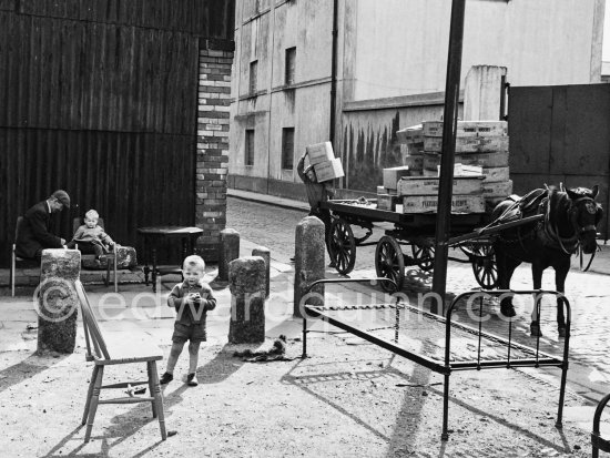 Boy at Anglesea Market, Dublin\'s secondhand market in a laneway off Moore Street. Dublin 1963. - Photo by Edward Quinn