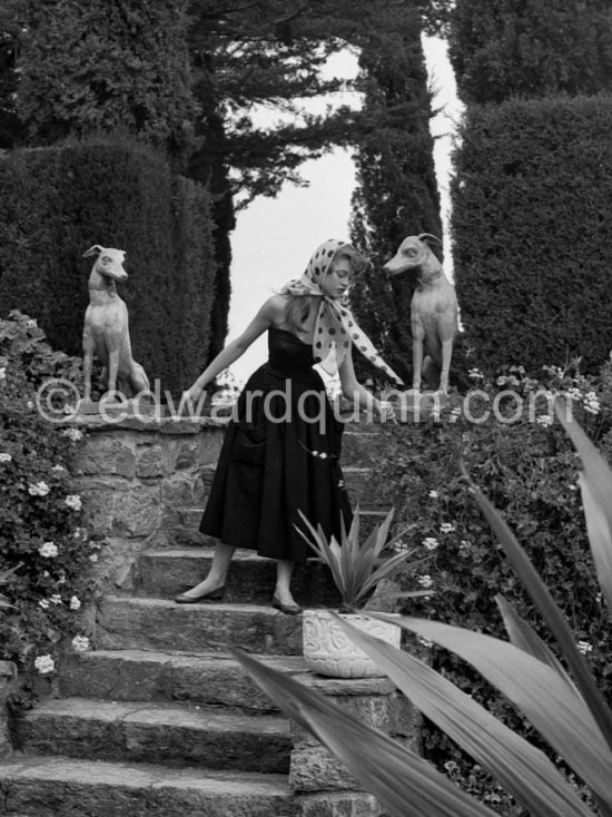 Brigitte Bardot posing with dog sculpture. Cannes Film Festival 1953. - Photo by Edward Quinn