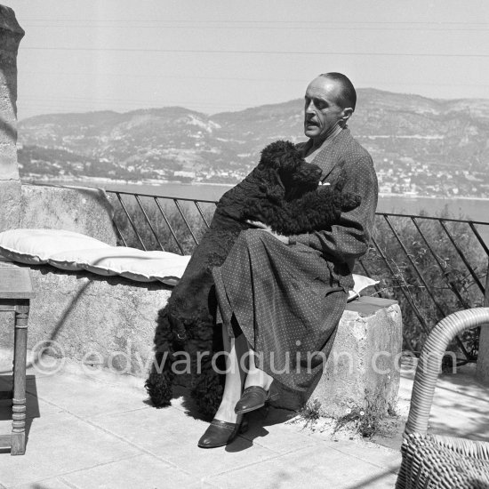 René Clair with his poodle on the terrace of his mansion. Sainte-Maxime 1953. - Photo by Edward Quinn