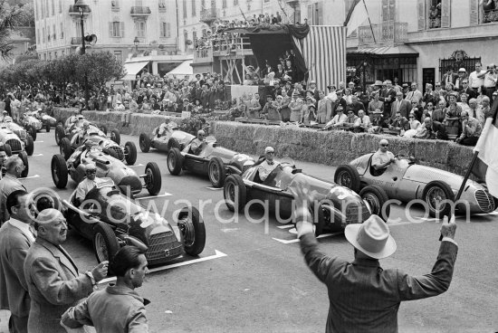 The flag in his hand, Charles Faroux, Clerk of the Course since the first edition, gets ready to give the start. Juan Manuel Fangio, (34) Alfa Romeo 158 Alfetta, winner of the Grand Prix. Farina, Giuseppe "Nino" Farina, (32) Alfa Romeo 158 Alfetta, Jose Froilan Gonzales "El Cabezon", (big head"), (2) Maserati 4CLT, Etancelin, Talbot-Lago T26C, (14) Fagioli, Alfa Romeo, (36) Ascari, Ferrari 125, (40) Chiron, Maserati 4CLT/48, (48). Winner of the race was Fangio. Monaco Grand Prix 1950. - Photo by Edward Quinn