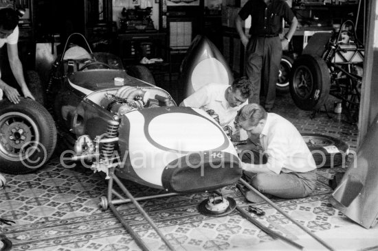 In a backstreet garage of Monte Carlo, Lance Reventlow, the driver-owner-constructor, helps to prepare his Scarab car for the race. Monaco Grand Prix 1960. - Photo by Edward Quinn