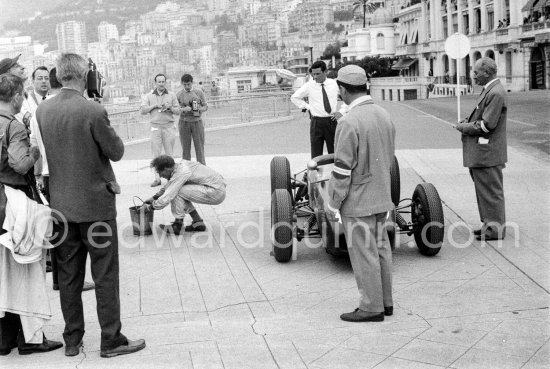 Innes Ireland pushes his N° 22 Lotus 18 uphill and right around the twisting Monaco circuit so that he can finish the race. His effort was repaid when he got 9th place and one point for the world championship. Monaco Grand Prix 1960. - Photo by Edward Quinn