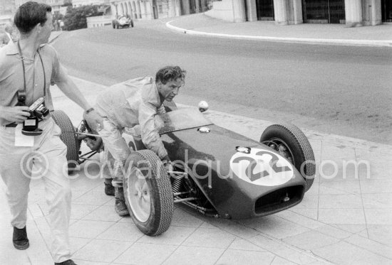 Innes Ireland pushes his N° 22 Lotus 18 uphill and right around the twisting Monaco circuit so that he can finish the race. His effort was repaid when he got 9th place and one point for the world championship. Monaco Grand Prix 1960. - Photo by Edward Quinn