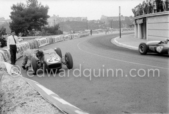 Innes Ireland pushes his N° 22 Lotus 18 uphill and right around the twisting Monaco circuit so that he can finish the race. His effort was repaid when he got 9th place and one point for the world championship. Monaco Grand Prix 1960. - Photo by Edward Quinn