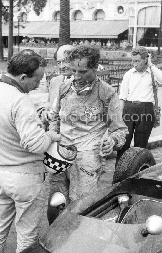 Innes Ireland pushes his N° 22 Lotus 18 uphill and right around the twisting Monaco circuit so that he can finish the race. His effort was repaid when he got 9th place and one point for the world championship. Monaco Grand Prix 1960. - Photo by Edward Quinn