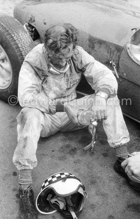 Innes Ireland pushes his N° 22 Lotus 18 uphill and right around the twisting Monaco circuit so that he can finish the race. His effort was repaid when he got 9th place and one point for the world championship. Monaco Grand Prix 1960. - Photo by Edward Quinn