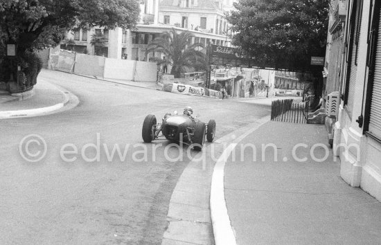 Innes Ireland pushes his N° 22 Lotus 18 uphill and right around the twisting Monaco circuit so that he can finish the race. His effort was repaid when he got 9th place and one point for the world championship. Monaco Grand Prix 1960. - Photo by Edward Quinn