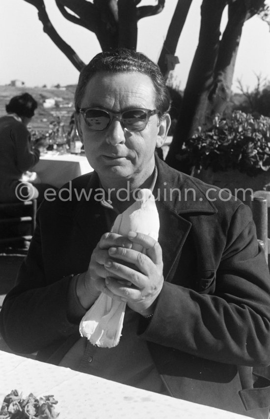 The painter Hans Hartung carefully holding a dove. At Restaurant Colombe d\'Or, Saint-Paul-de-Vence 1961. - Photo by Edward Quinn