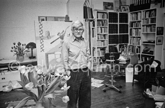 David Hockney in front of on "Self portrait with blue guitar". London 1977. - Photo by Edward Quinn