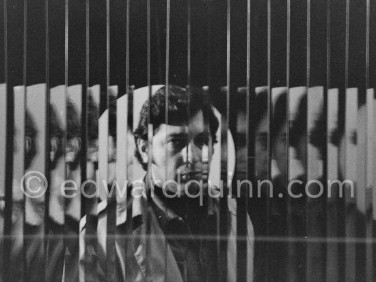 Argentine kinetic and Op artist Julio Le Parc behind one of his works at the Gallery Denise René rive gauche. Exhibition "L’idée et la matière", Paris 1974. - Photo by Edward Quinn