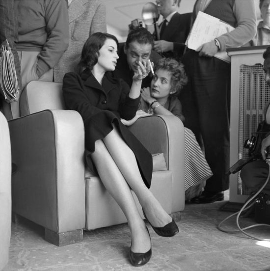 No relaxing for Silvana Mangano. After lunch at the famous restaurat La Bonne Auberge at Antibes, Silvana satisfies the ever present journalists. Antibes 1955. - Photo by Edward Quinn