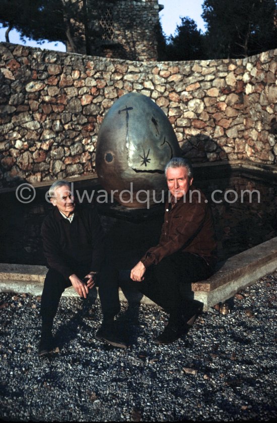 Joan Miró and Aimé Maeght in the gardens of Musée Maeght in front of a small pool with an "Oeuf cosmique" by Miró in center. Saint-Paul-de-Vence 1964. - Photo by Edward Quinn