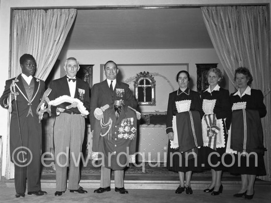 The Prince\'s six servants, each holds part of his uniform - red trousers for gala occasions, blue for ceremonials. Monaco 1954. - Photo by Edward Quinn