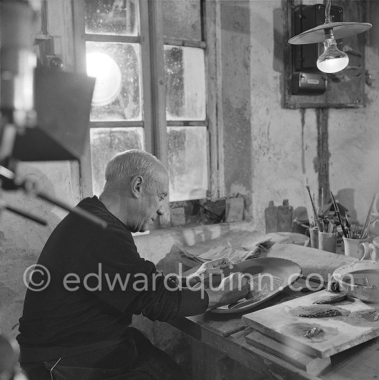 Pablo Picasso working on first version of plate of a woman (Irène Rignault, Madame X), during filming of "Pablo Picasso", directed by Luciano Emmer. Madoura pottery, Vallauris 14.10.1953. - Photo by Edward Quinn