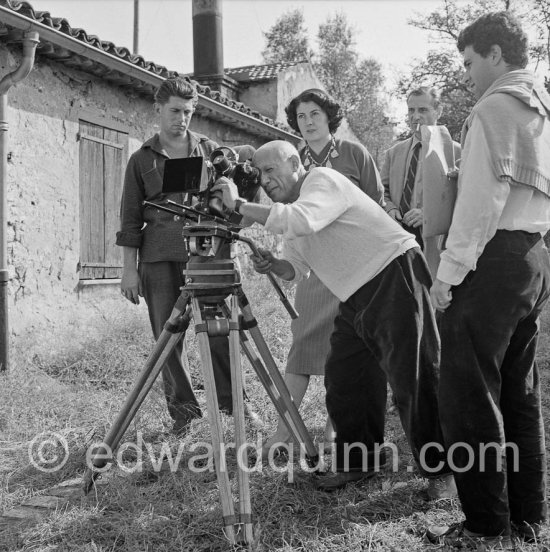 Pablo Picasso checking a camera angle (documentary film of Luciano Emmer). With Paulo Picasso and Madame Paule de Lazerme (she had an affair with Pablo Picasso for some months) who wears a necklace designed by Pablo Picasso. Two not yet identified persons. In front of the studio Le Fournas, Vallauris 1953. - Photo by Edward Quinn