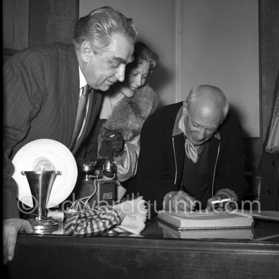 Pablo Picasso signing guestbook. With Sovjet Film delegation Grigori Alexandrov (director) and Ljubov Orlova. Temple de la Paix, (or Chapelle de la Paix), today Musée national Pablo Picasso, La Guerre et La Paix, Vallauris 1954. - Photo by Edward Quinn