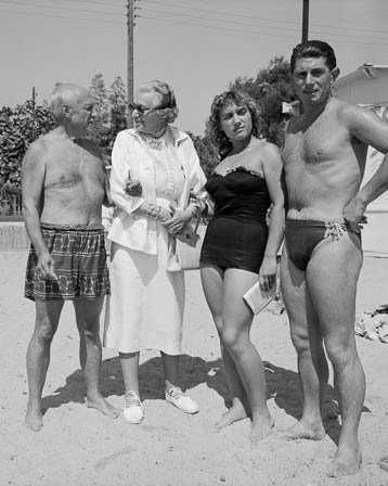 Pablo Picasso with Marie Cuttoli, close friend and collector of his works and Paulo Picasso and Maya Picasso. Golfe-Juan 1954. - Photo by Edward Quinn