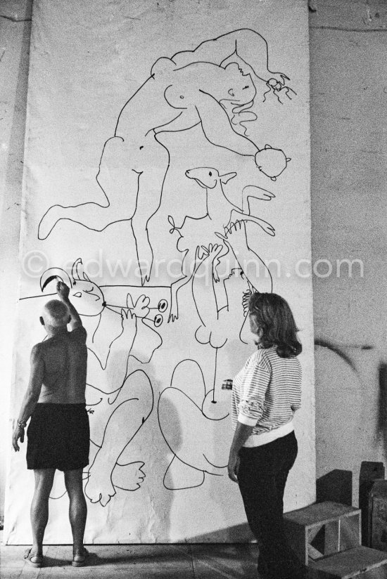 Pablo Picasso working on a bucolic pastoral scene on drawing paper which was to serve as background for the film "Le mystère Picasso". Maya Picasso on the right. Nice, Studios de la Victorine 1955. - Photo by Edward Quinn