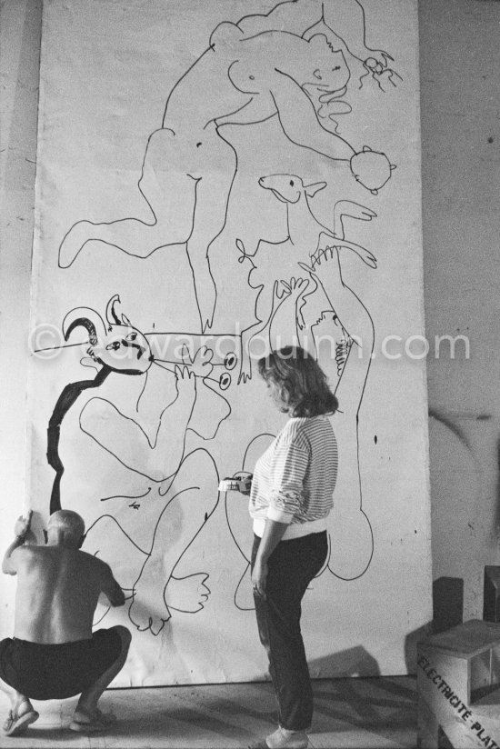 Pablo Picasso working on a bucolic pastoral scene on drawing paper which was to serve as background for the film "Le mystère Picasso". Maya Picasso on the right. Nice, Studios de la Victorine 1955. - Photo by Edward Quinn