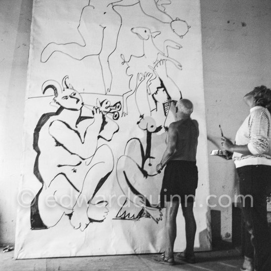 Pablo Picasso working on a bucolic pastoral scene on drawing paper which was to serve as background for the film "Le mystère Picasso". Maya Picasso on the right. Nice, Studios de la Victorine 1955. - Photo by Edward Quinn