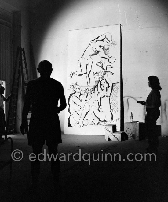 Pablo Picasso working on a bucolic pastoral scene on drawing paper which was to serve as background for the film "Le mystère Picasso". Maya Picasso on the right. Nice, Studios de la Victorine 1955. - Photo by Edward Quinn