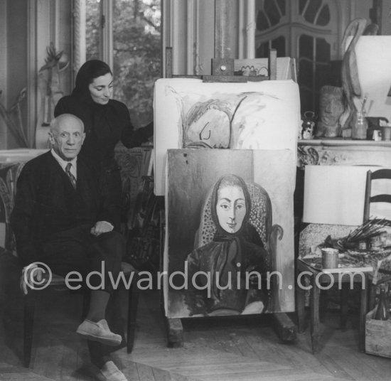 Pablo Picasso and Jacqueline with the painting "Portrait de Jacqueline au rocking-chair et à la mantille noire". La Californie, Cannes 1955. (Digitized from Vintage Print, original negative missing) - Photo by Edward Quinn