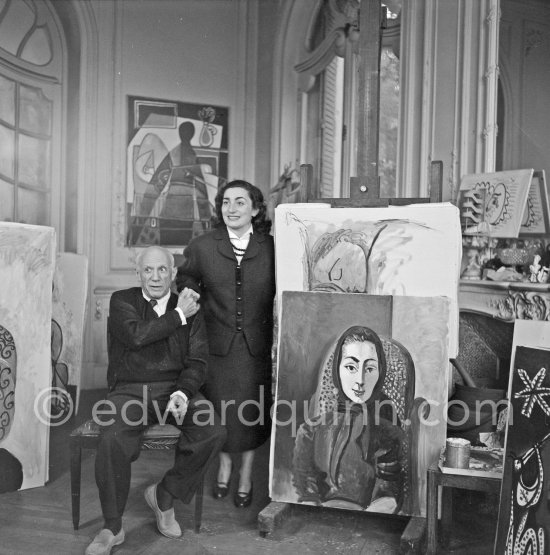 Pablo Picasso and Jacqueline with the painting "Portrait de Jacqueline au rocking-chair et à la mantille noire". La Californie, Cannes 1955. - Photo by Edward Quinn