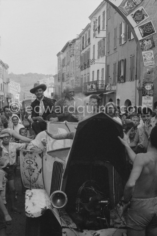 Pablo Picasso and Maya Picasso in the Renault 1925 with bull\'s horns on the traditional parade after a local corrida. Vallauris 1956. Avenue Georges Clément 14, on the right entrance to Nérolium. Vallauris 1956. Same situation of today see Pic560419 - Photo by Edward Quinn