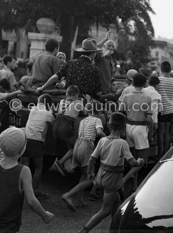 Pablo Picasso and Maya Picasso at the traditional parade after a local corrida in the Renault 1925 with bull\'s horns. Vallauris 1956 - Photo by Edward Quinn