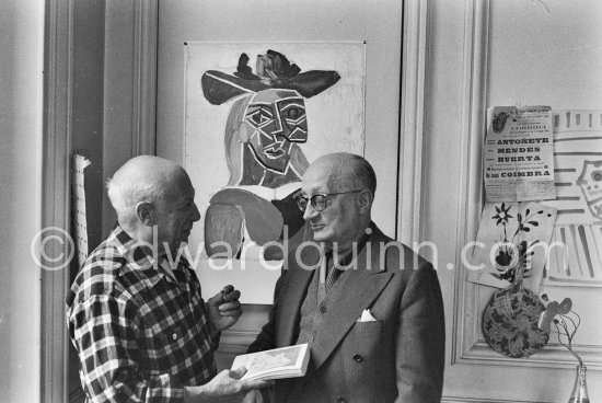 Pablo Picasso and his friend and secretary Jaime Sabartés with the book Pablo Picasso: documents iconographiques. La Californie, Cannes 1956. - Photo by Edward Quinn