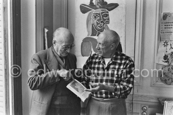 Pablo Picasso and his friend and secretary Jaime Sabartés with the book Pablo Picasso: documents iconographiques. La Californie, Cannes 1956. - Photo by Edward Quinn