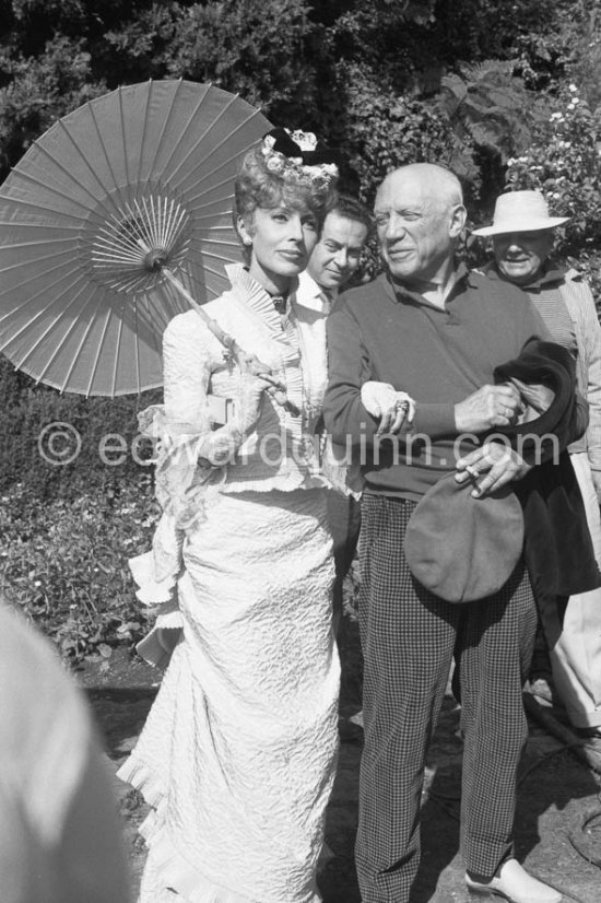 Pablo Picasso and Francine Weisweiller, Renato Guttuso and Alberto Magnelli in the background. During filming of "Le Testament d’Orphée", film of Jean Cocteau. At Villa Santo Sospir of Francine Weisweiller. Saint-Jean-Cap-Ferrat 1959. - Photo by Edward Quinn