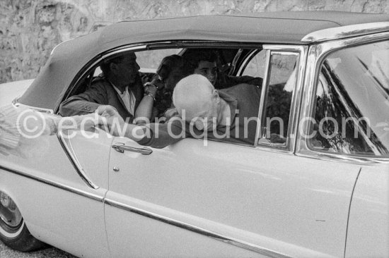 Pablo Picasso saying good-bye to Francine Weisweiller, in his Lincoln Premier Convertible 1957 driven by chauffeur Marcel. Jacqueline, Catherine Hutin, Renato Guttuso, during filming of "Le Testament d’Orphée". Saint-Jean-Cap-Ferrat 1959. - Photo by Edward Quinn