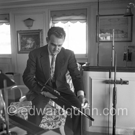 Prince Rainier with a harpoon on board his yacht Deo Juvante II anchored at Monaco harbor, Nov. 1953. - Photo by Edward Quinn