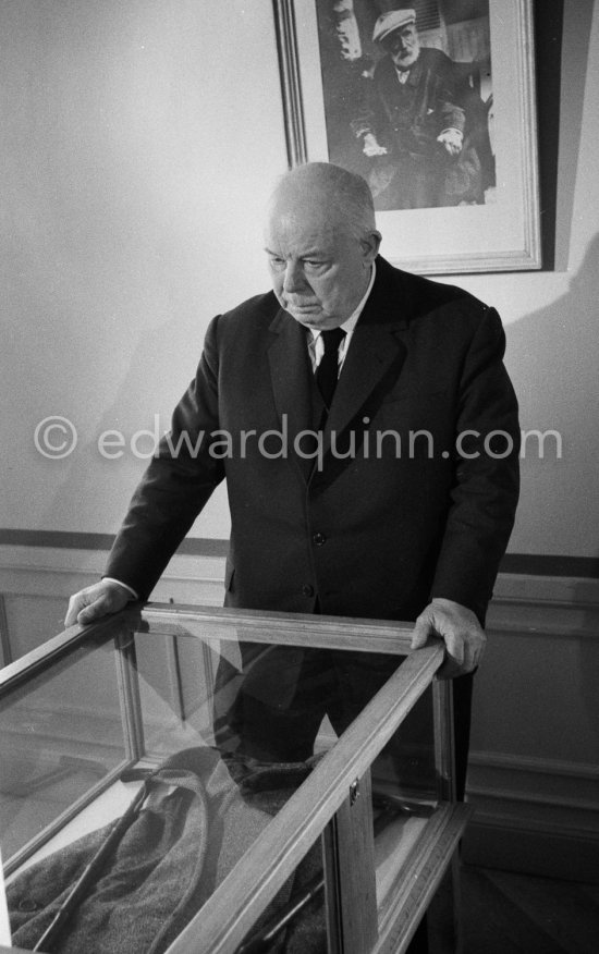 Jean Renoir at the reconstructed studio of his father Auguste Renoir. At the wall the photo of his father. At Domaine des Collettes, the estate of the Renoir family. Cagnes-sur-Mer 1962. - Photo by Edward Quinn