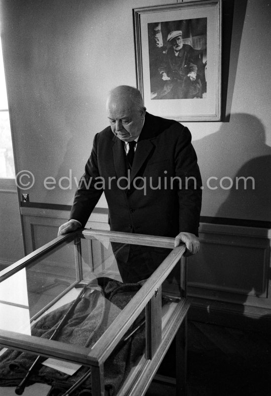 Jean Renoir at the reconstructed studio of his father Auguste Renoir. At the wall the photo of his father. At Domaine des Collettes, the estate of the Renoir family. Cagnes-sur-Mer 1962. - Photo by Edward Quinn