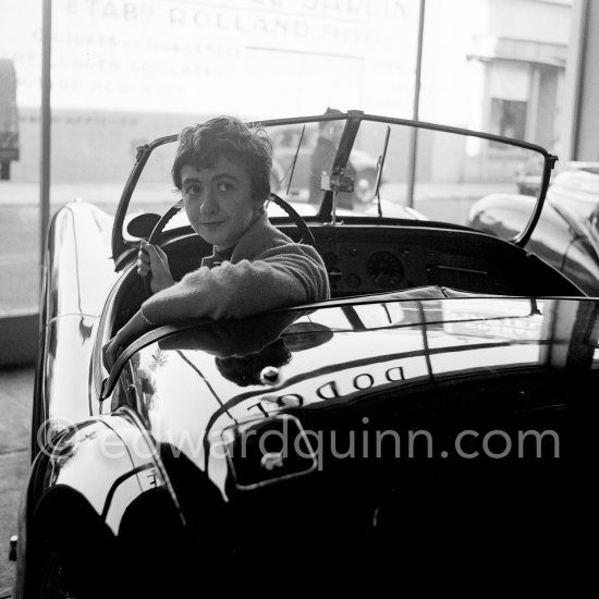 Françoise Sagan evaluating a Jaguar XK120 at the showroom of a Jaguar dealer in Cannes 1954. - Photo by Edward Quinn