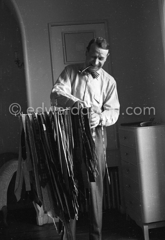 Georges Simenon with his ties at his Villa Golden Gate. Cannes 1955. - Photo by Edward Quinn