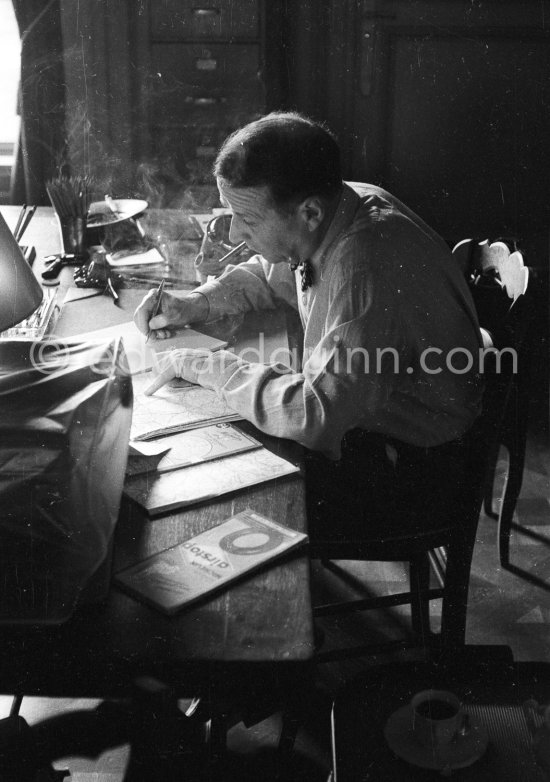 Georges Simenon at his desk. Villa Golden Gate, Cannes 1955. - Photo by Edward Quinn