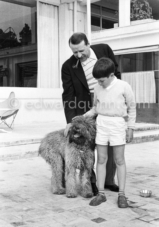 Georges Simenon with his poodle Mister and Charlie Chaplin\'s son Michael Chapin at his Villa Golden Gate. Cannes 1955 - Photo by Edward Quinn