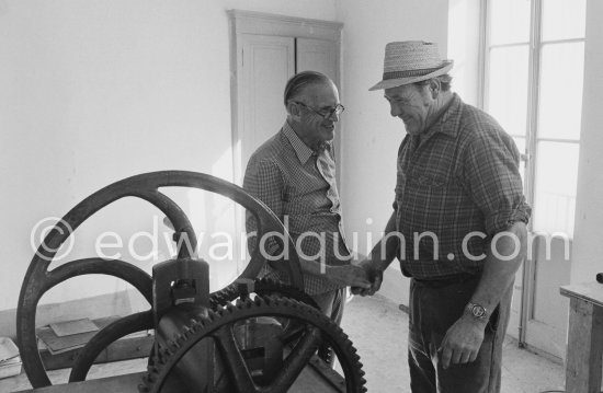 Graham Sutherland and a not yet identified person. installing a printing press at La Villa Blanche. Menton 1974. - Photo by Edward Quinn