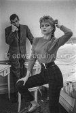 Brigitte Bardot being photographed by her husband Roger Vadim in their room at the Hotel Negresco. With a portable radio. Nice 1955. - Photo by Edward Quinn