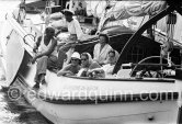 Princess Beatrix of the Netherlands, later Queen, on her boat De groene Draeck (laughing, with white jacket) In front with shawl and sonen glasses her sister Irene. Saint-Tropez 1958. - Photo by Edward Quinn