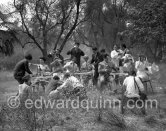 Paul Meurisse (white suit) during filming of “Le Déjeuner sur l'herbe” at the Auguste Renoir house "Les Collettes". With the aid of mechanical wind devices a tempest, the mistral, turns the déjeuner into catastrophe. Cagnes-sur-Mer 1959. - Photo by Edward Quinn